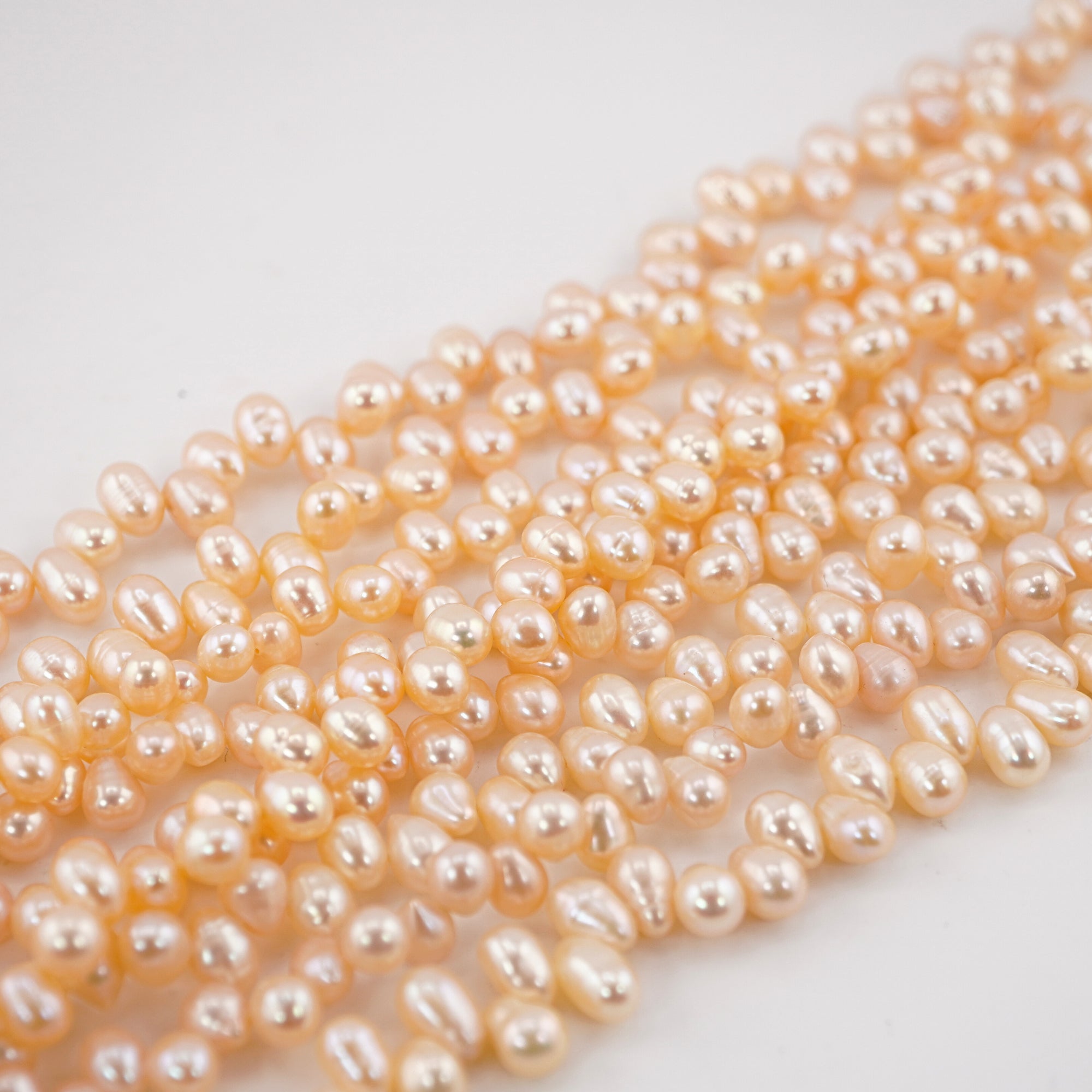 7 x 5 - 6 x 5 MM Peach Oval Freshwater Pearls Beads