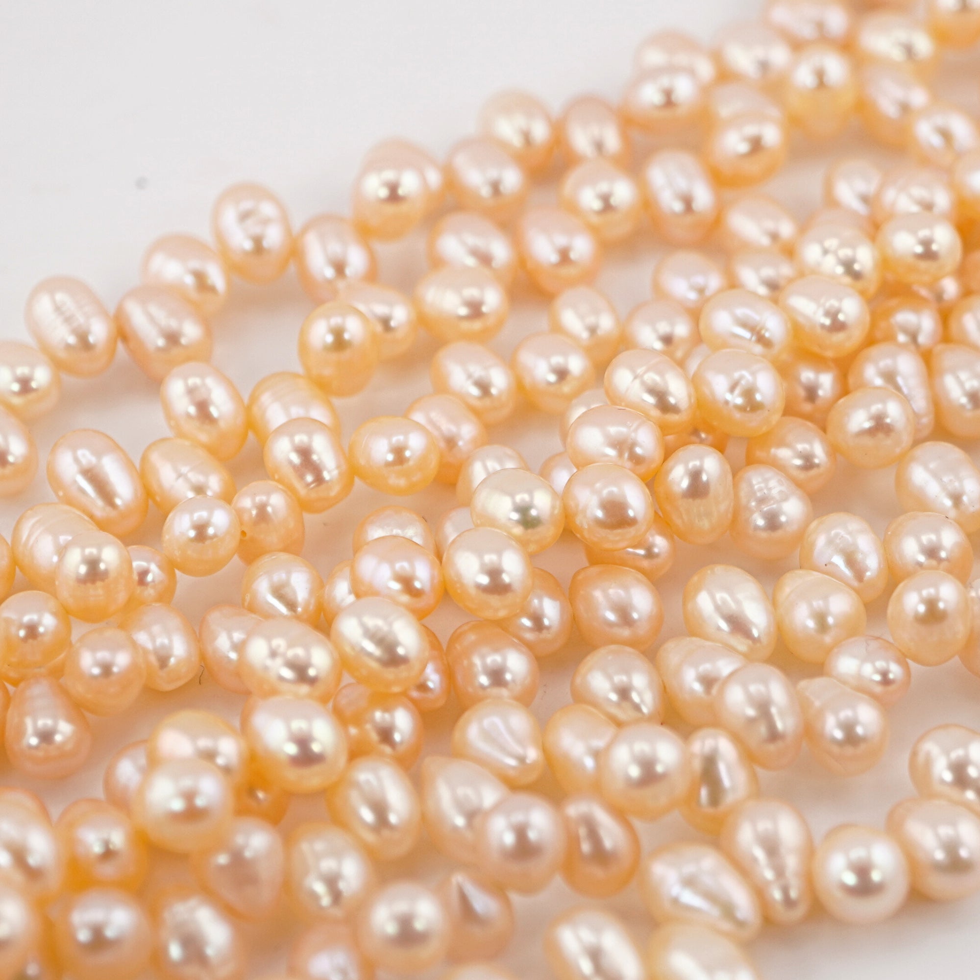7 x 5 - 6 x 5 MM Peach Oval Freshwater Pearls Beads