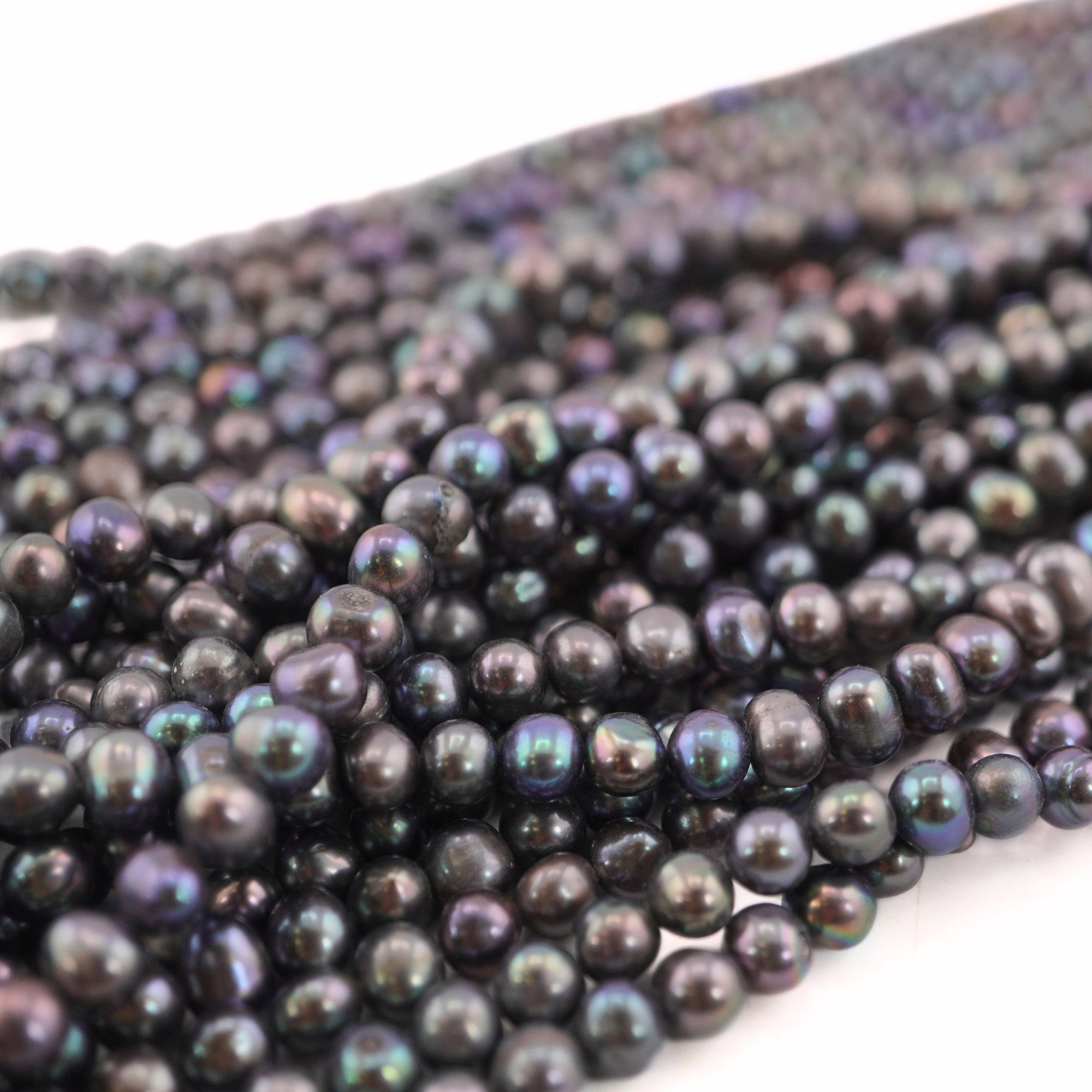 Iridescent peacock pearls in potato shape

