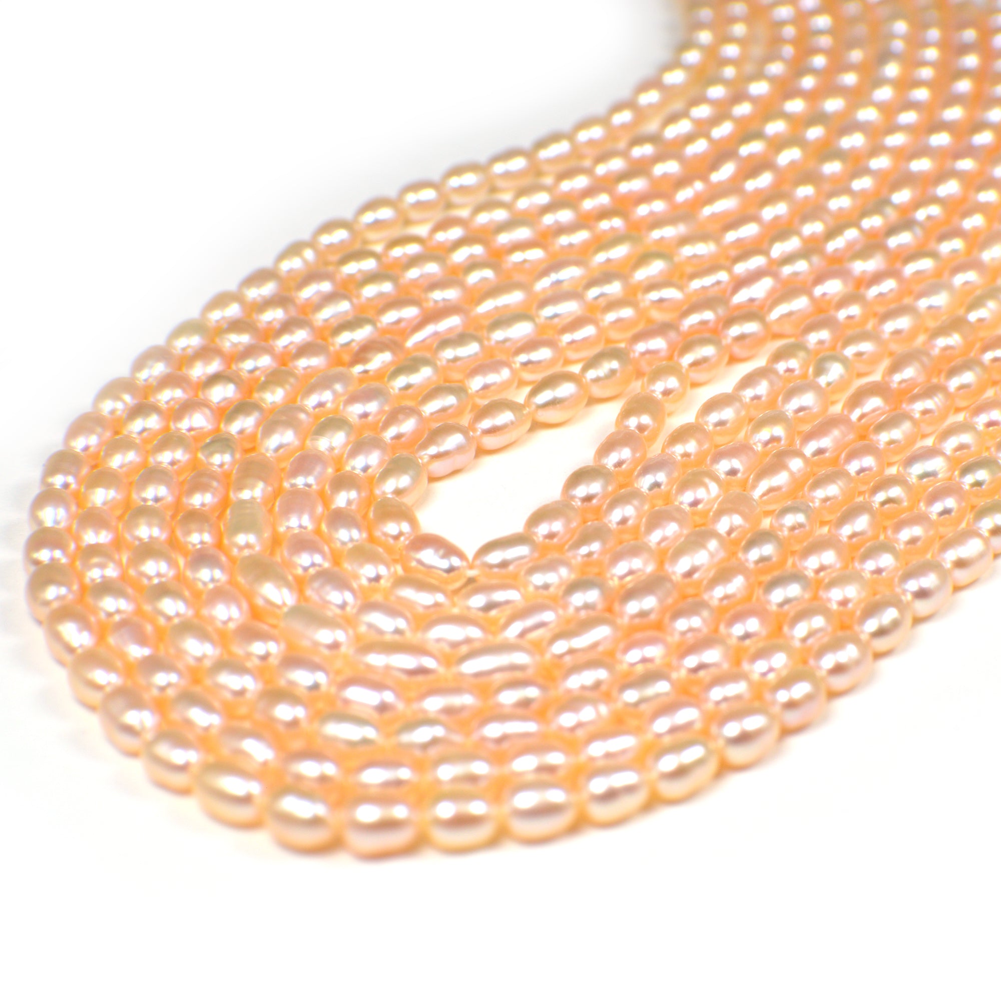 6.5x5.5 - 7.5x5.5 MM Light Peach Rice / Oval Freshwater Pearls Beads