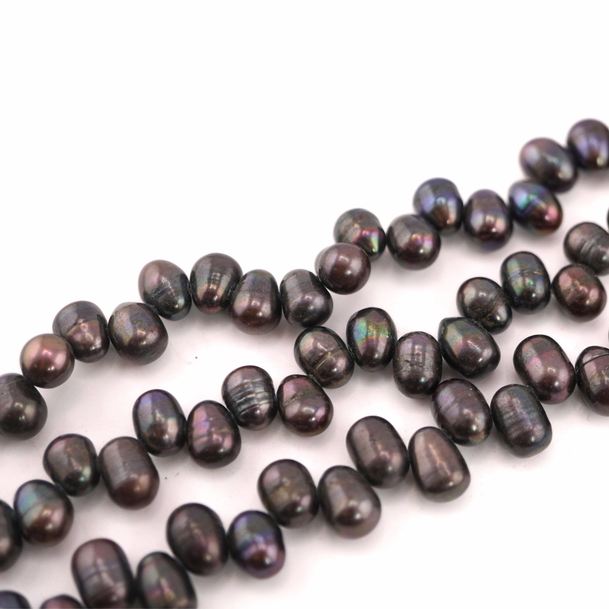 Lustrous peacock colored oval pearls

