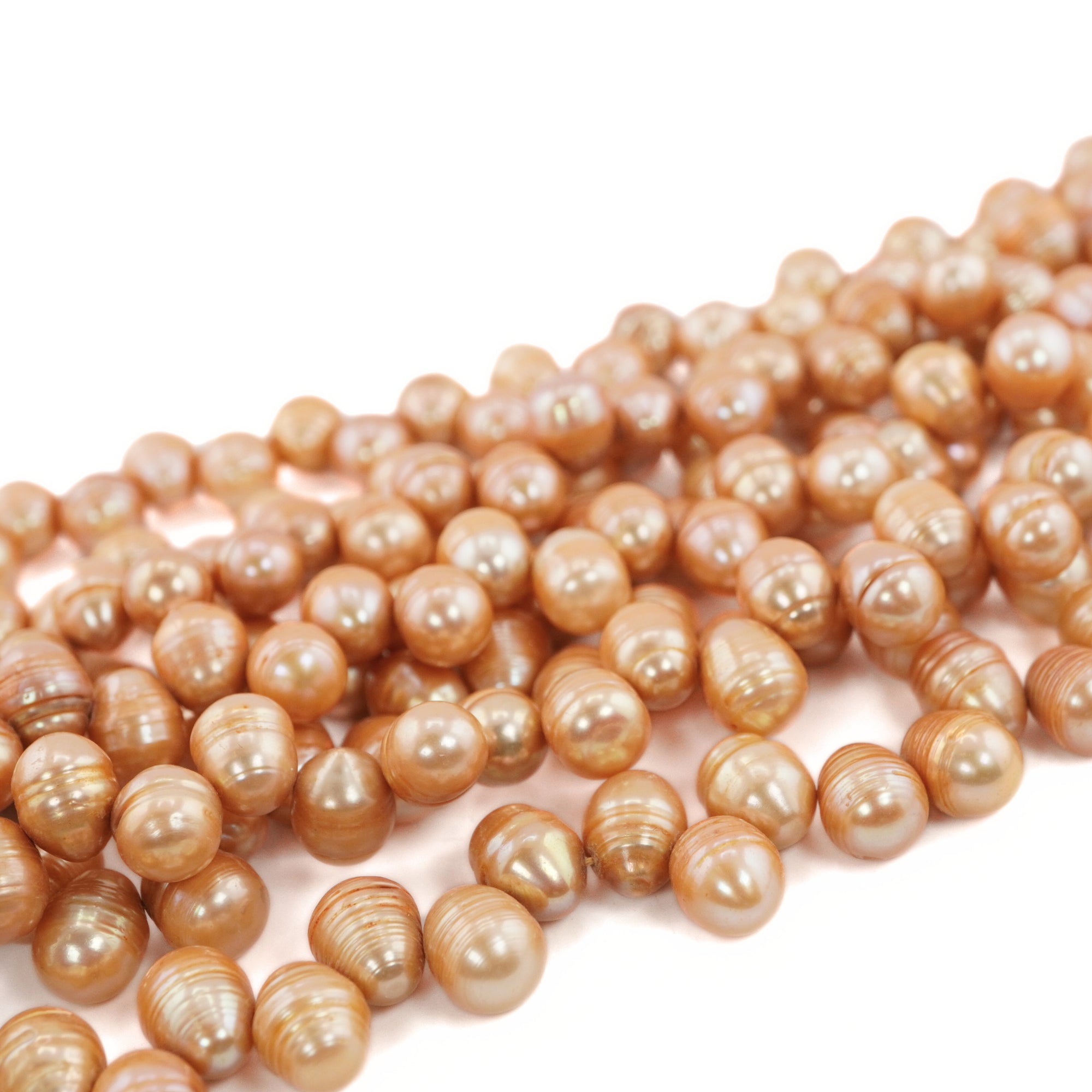 close-up of peach oval pearl strand

