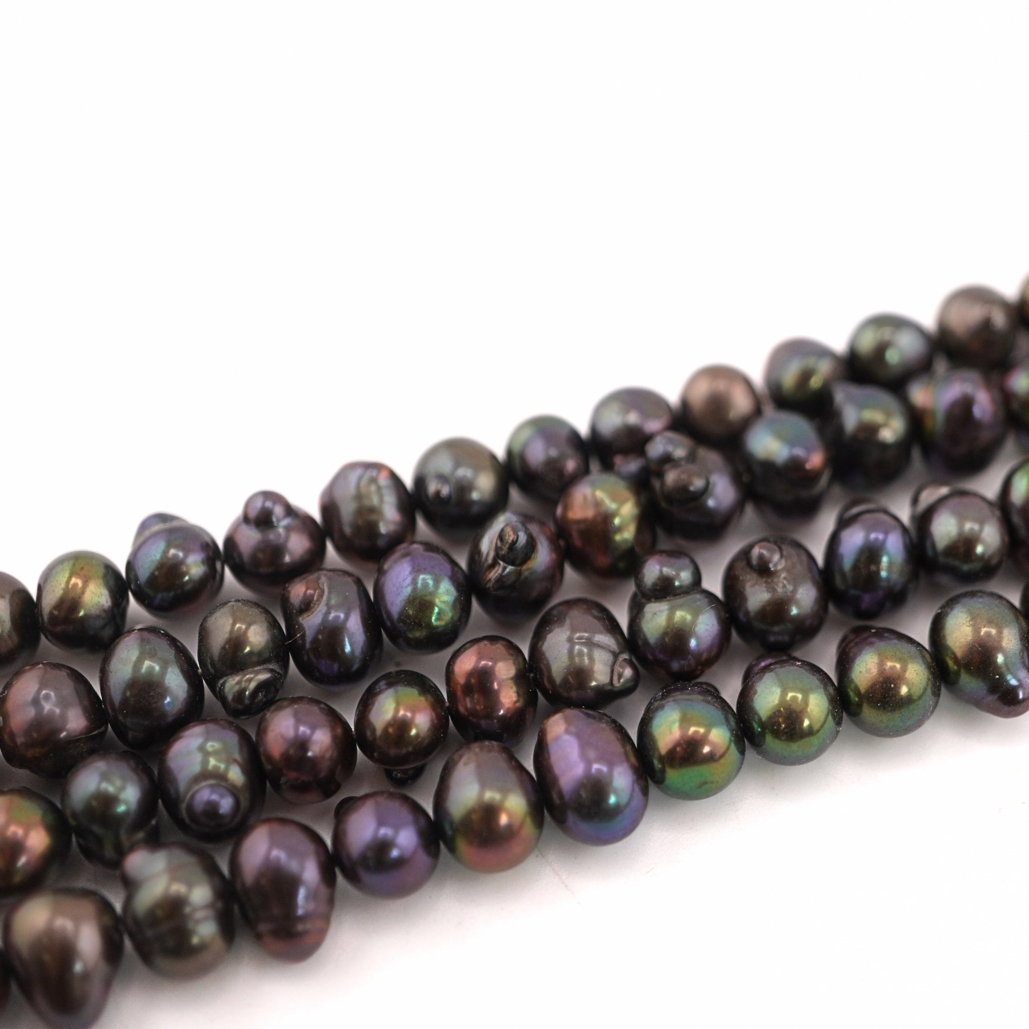 oval freshwater beads in peacock color

