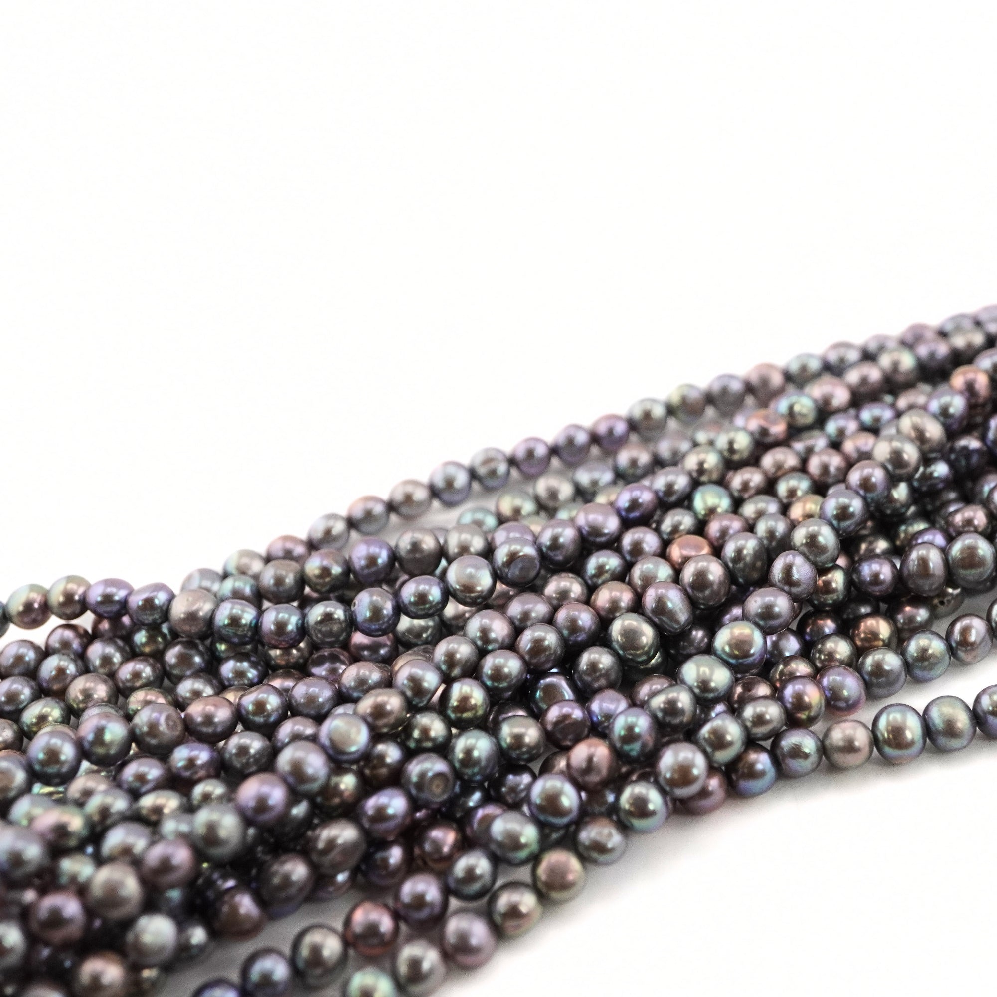 peacock near round gemstone beads

